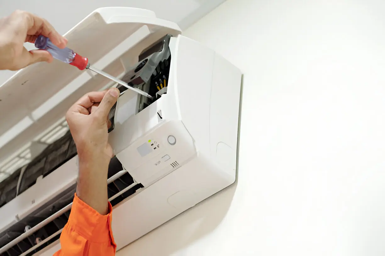 HVAC specialist troubleshooting a broken air conditioner in a Los Angeles home